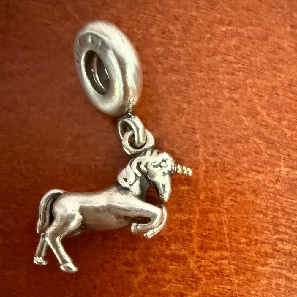 Pandora unicorn dangle charm. Silver with gold horn.